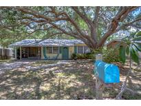 House exterior featuring a large tree and a blue mailbox at 5210 Newton S Ave, Gulfport, FL 33707