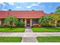 Exterior view of a charming condo with landscaping at 19029 Us Highway 19 N # 12B, Clearwater, FL 33764