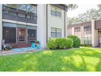 A charming condo with lush landscaping and a cozy patio area at 2400 Winding Creek Blvd # 25-101, Clearwater, FL 33761