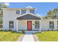 Modern two-story house with a red door and gray siding at 1216 15Th S Ave, St Petersburg, FL 33705