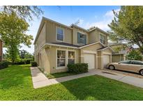 Two story house with attached garage and manicured lawn at 2032 Sunset Meadow Dr, Clearwater, FL 33763