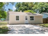 Charming light beige house with white trim and a spacious driveway at 4000 7Th N Ave, St Petersburg, FL 33713