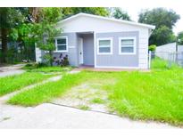 Updated bungalow style home with gray siding and a small front yard at 3207 E 23Rd Ave, Tampa, FL 33605