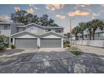 Two-car attached garage with gray doors at 9247 Jakes Path, Largo, FL 33771