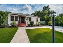 Quaint single-story home with manicured lawn and walkway at 315 Princess St, Clearwater, FL 33755