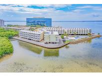 Aerial view of waterfront condo building with parking and pool at 2506 N Rocky Point Dr # 274, Tampa, FL 33607
