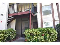 Inviting condo exterior featuring a private entrance, balcony, and lush landscaping at 3455 Countryside Blvd # 15, Clearwater, FL 33761