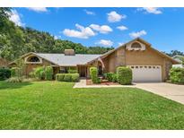 Charming single-story house with a well-maintained lawn at 3045 Kevlyn Ct, Safety Harbor, FL 34695