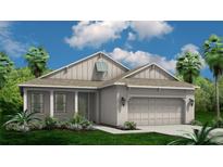 Charming one-story house with light beige exterior and two-car garage at 9261 Highland Hills Dr, Hudson, FL 34667