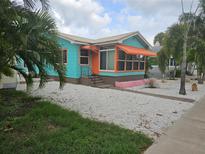 Charming Florida bungalow with teal exterior and orange awning at 3108 58Th S St, Gulfport, FL 33707