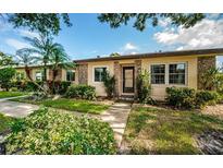 Cute condo exterior with landscaping and walkway at 865 Maclaren N Dr # D, Palm Harbor, FL 34684