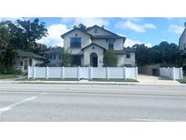 Two-story house with white vinyl fence, a driveway, and landscaping at 1301 22Nd N Ave, St Petersburg, FL 33704
