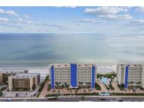 Expansive aerial view of condo complex with beach access and beautiful blue ocean views on a sunny day at 14950 Gulf Blvd # 404, Madeira Beach, FL 33708