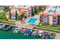 Aerial view of waterfront community with pool and boat slips at 8911 Blind Pass Rd # 305, St Pete Beach, FL 33706