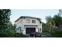 Stunning two-story home with a modern design, lush landscaping, and a stylish black car parked in the driveway at 1045 Conant Ave, Safety Harbor, FL 34695