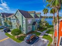 Green two story townhouse near a lake at 9028 Lake Chase Island Way, Tampa, FL 33626