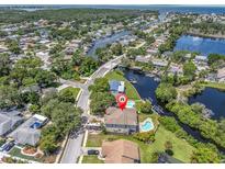 Aerial view showcasing home's location near the water at 435 Westwinds Drive, Palm Harbor, FL 34683
