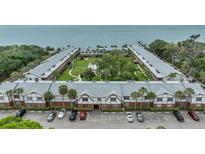 Aerial view of waterfront community with pool and parking at 650 Pinellas Point S Dr # 106, St Petersburg, FL 33705