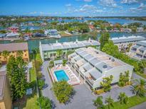 Aerial view of waterfront community with pool and boat slips at 320 Windrush Blvd # 4, Indian Rocks Beach, FL 33785