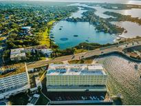 Stunning aerial view of a waterfront community with lush greenery and calm waters, perfect for boating enthusiasts at 100 Bluff View Dr # 405C, Belleair Bluffs, FL 33770