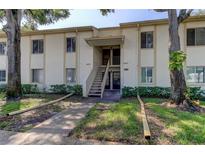 Exterior of a condo building showcasing stairs and landscaping at 106 Pine Ct # 106, Oldsmar, FL 34677