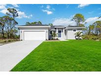 New single-story home with a white garage door and landscaped lawn at 14191 Salvatierra Ln, Port Charlotte, FL 33981