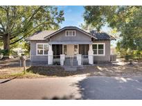Charming bungalow exterior, gray siding, white trim, and a welcoming front porch at 907 E North Bay St, Tampa, FL 33603