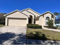 Charming single-Gathering home with a two-car garage and well-maintained front yard at 418 Henderson Ave, Seffner, FL 33584