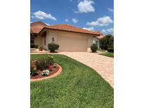 Charming single-story home with a tile roof, paver driveway, and beautifully landscaped front yard at 4041 Murfield E Dr, Bradenton, FL 34203