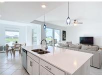 Bright open-plan living room with modern island kitchen, dining area, and stylish contemporary furniture at 14204 Heritage Landing Blvd # 714, Punta Gorda, FL 33955