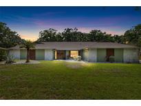 Inviting single-story home featuring manicured lawn, mature trees, and beautiful landscaping, providing great curb appeal at 4301 Hudson Ln, Tampa, FL 33618
