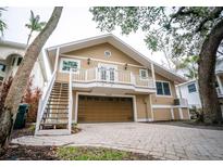 Two-story home featuring a balcony, stairs, a two car garage and a well-kept paved driveway at 5169 Oxford Dr, Sarasota, FL 34242