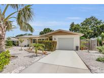 Charming single-story home with manicured landscaping, a driveway, and a welcoming entrance at 6012 1St W Ave, Bradenton, FL 34209