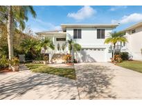 Two-story house with attached garage and landscaped yard at 6225 Bayside Dr, New Port Richey, FL 34652