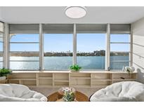 Relaxing water view from an open living space, featuring comfortable seating and natural light at 770 Island Way # N302, Clearwater, FL 33767