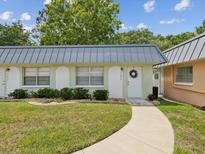 Front view of light green condo building at 11935 Bayonet Ln # 0, New Port Richey, FL 34654