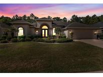 Attractive single-story home with landscaping and two-car garage at 5378 Legend Hills Ln, Spring Hill, FL 34609