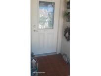 Inviting condo entry with a decorative glass door and tiled flooring at 8210 Aquila St # 226, Port Richey, FL 34668