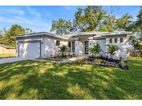 Beautifully landscaped home with modern design, featuring a well-manicured lawn and fresh curb appeal at 9229 Creston Ave, New Port Richey, FL 34654