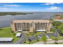 Aerial view of a three-story waterfront condo building with parking at 4550 Bay Blvd # 1224, Port Richey, FL 34668