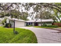 House exterior with driveway and landscaping at 1423 Meadow Lark Rd, Spring Hill, FL 34608