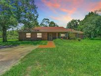 Brick ranch house with large yard and driveway at 18101 Moorhaven Dr, Spring Hill, FL 34610