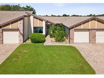 Front view of a two-story home with two car garage at 7428 Heather Walk Dr, Weeki Wachee, FL 34613