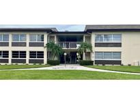 Condo building exterior with entrance and landscaping at 5123 Topaz Ln # 105, New Port Richey, FL 34652