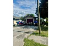 House exterior with garage and multiple vehicles parked on the property at 3310 68Th N Ave, St Petersburg, FL 33702