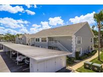 Charming condo featuring a two-story building with carport parking in a well-maintained community at 7712 Hillside Ct # 202, Hudson, FL 34667