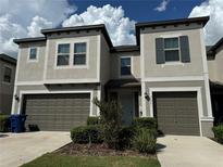 Two-story house with two-car garage and landscaping at 31941 Blue Passing Loop, Wesley Chapel, FL 33545