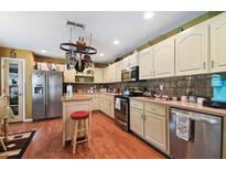 Spacious kitchen with island and stainless steel appliances at 17852 Fancy Ln, Hudson, FL 34667