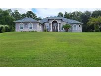 Two-story home with a large front yard at 11033 Baywind Ct, Weeki Wachee, FL 34613