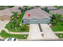 Aerial view of a two-story house with a two-car garage at 12200 Putter Green Ct, New Port Richey, FL 34654